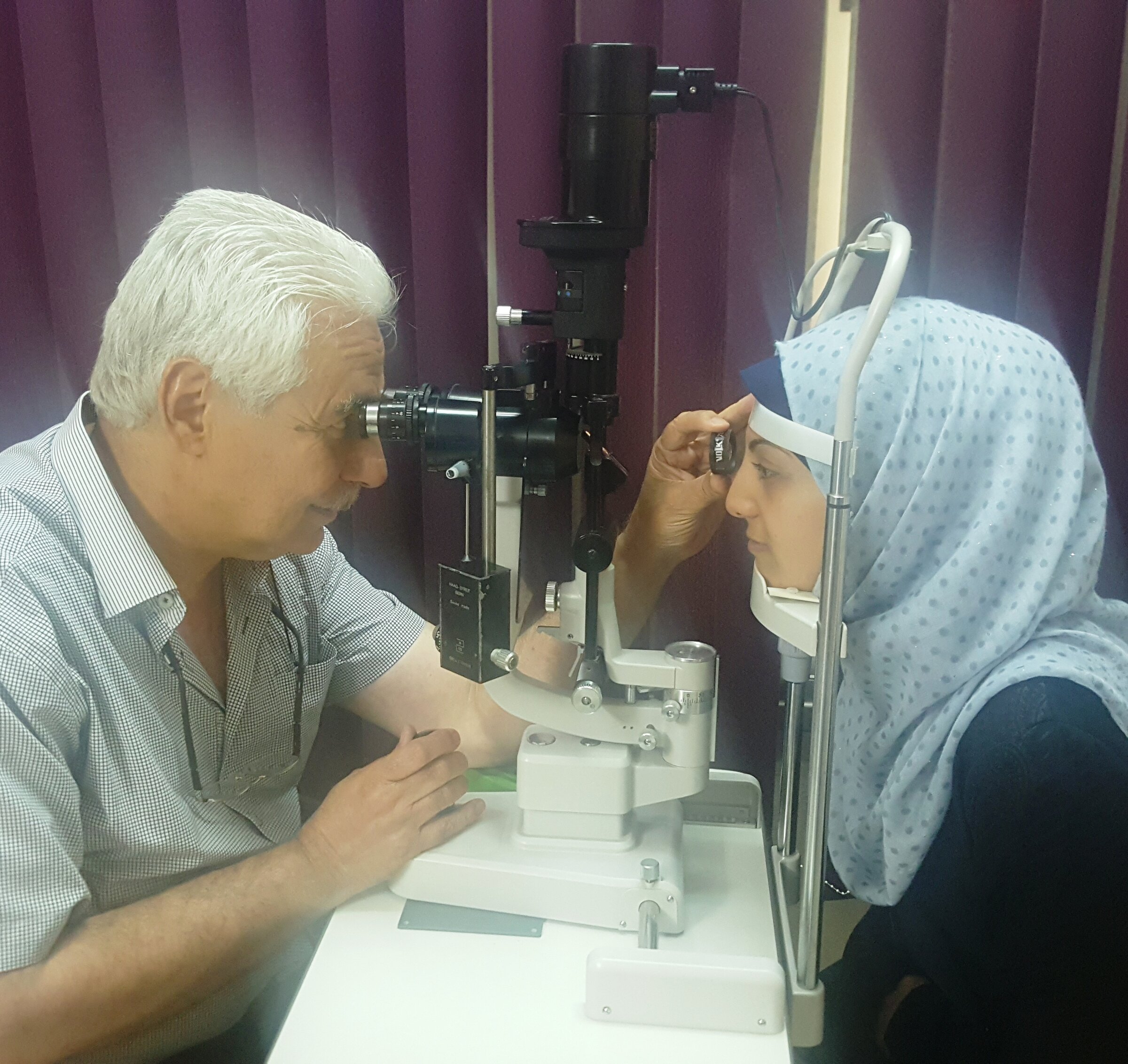 Photo of an eye examination of Dr. Abu-Ramadan at a female client