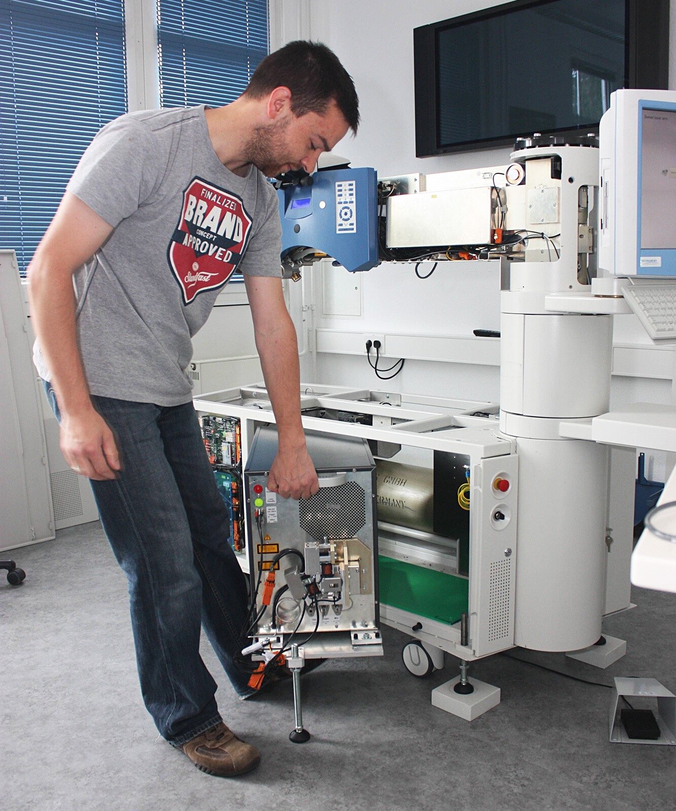 Service technician Daniel Fries swivels out the laser source